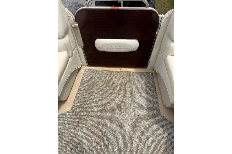 Slide: The Image of Interior view of a 2008 Sylvan 8523 Mandalay RE boat with carpeted flooring. - 17