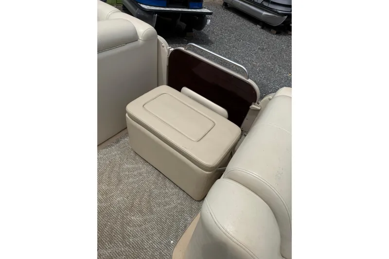 Slide: The Image of 2008 Sylvan 8523 Mandalay RE boat interior with beige seating and storage compartment. - 20