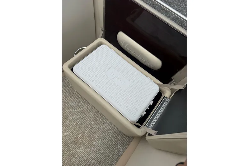 Slide: The Image of White Igloo cooler inside 2008 Sylvan 8523 Mandalay RE boat compartment. - 21