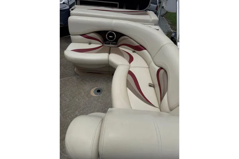 Slide: The Image of Luxurious seating on 2008 Sylvan 8523 Mandalay RE pontoon boat, featuring beige and maroon upholstery. - 23