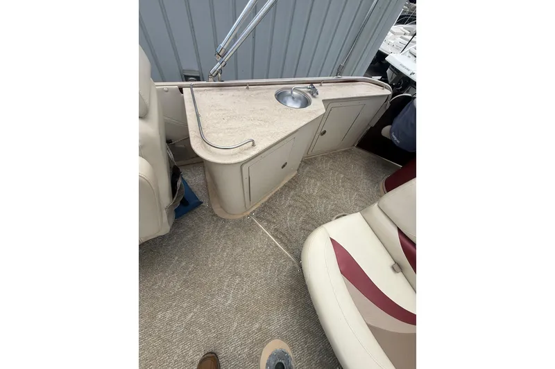 Slide: The Image of 2008 Sylvan 8523 Mandalay RE boat interior with sink and seating area. - 24