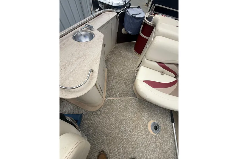 Slide: The Image of 2008 Sylvan 8523 Mandalay RE boat interior with sink and seating area. - 25