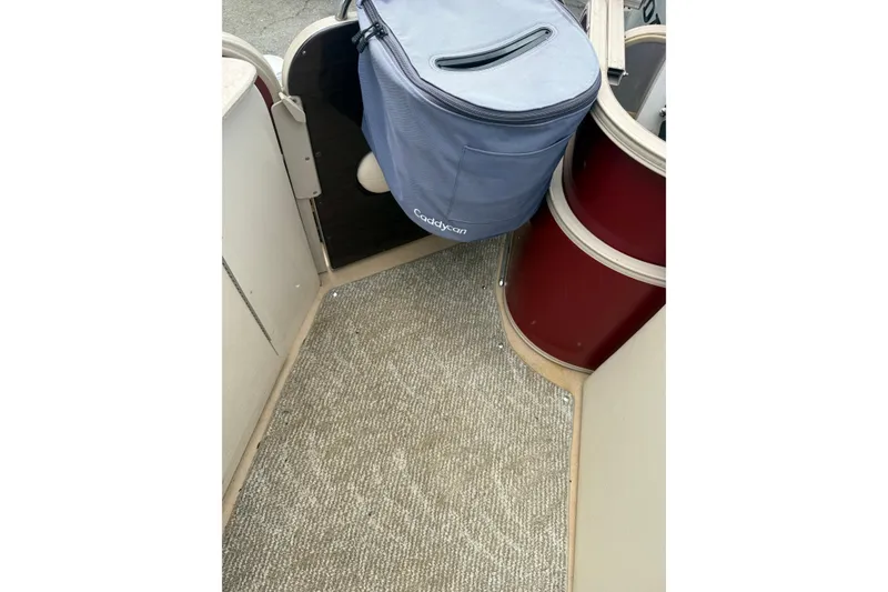 Slide: The Image of Interior view of a 2008 Sylvan 8523 Mandalay RE boat with carpeted flooring. - 26