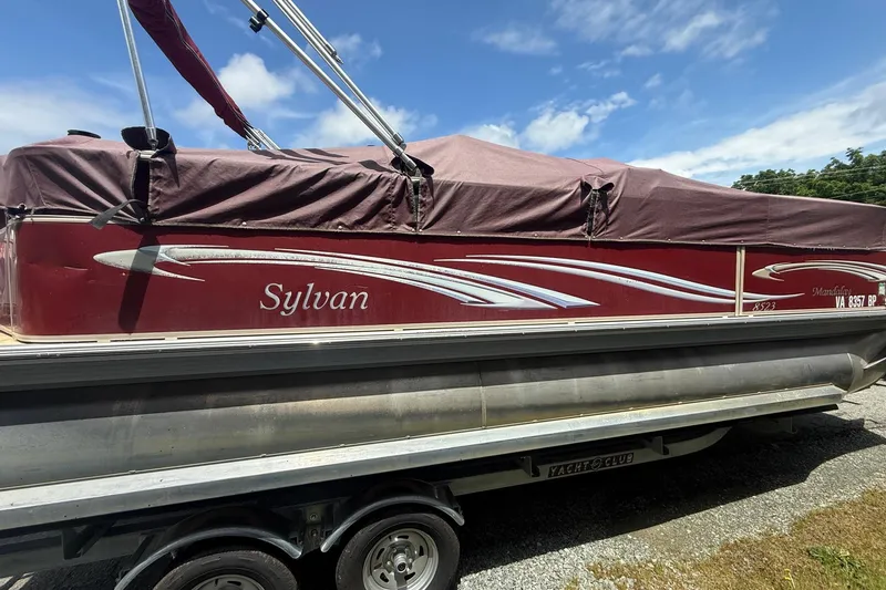 Slide: The Image of 2008 Sylvan 8523 Mandalay RE pontoon boat with maroon cover on trailer. - 4