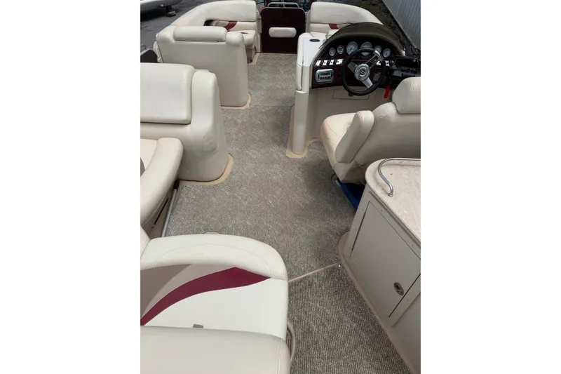 Slide: The Image of Interior of 2008 Sylvan 8523 Mandalay RE pontoon boat with beige seating and steering console. - 7