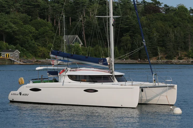 The Image of 2009 Fountaine Pajot Orana 44 catamaran anchored in a serene coastal setting. - 0
