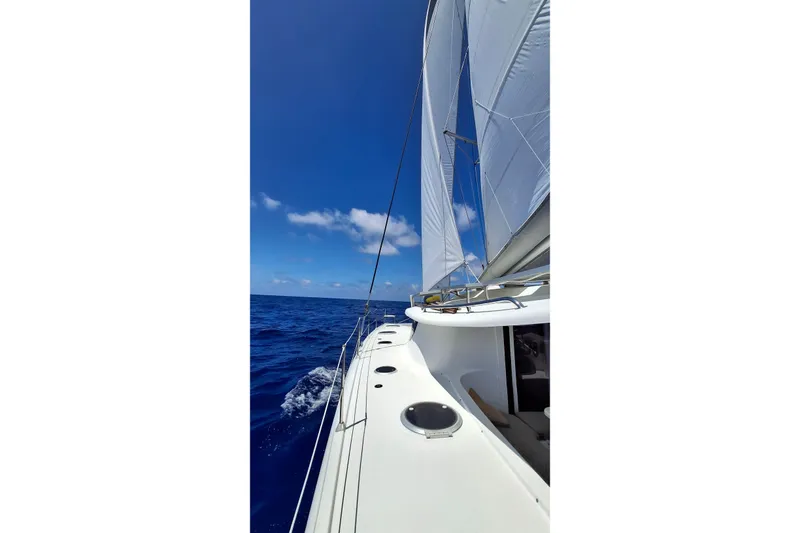 Slide: The Image of Sailing on a 2009 Fountaine Pajot Orana 44 catamaran under clear blue skies. - 10