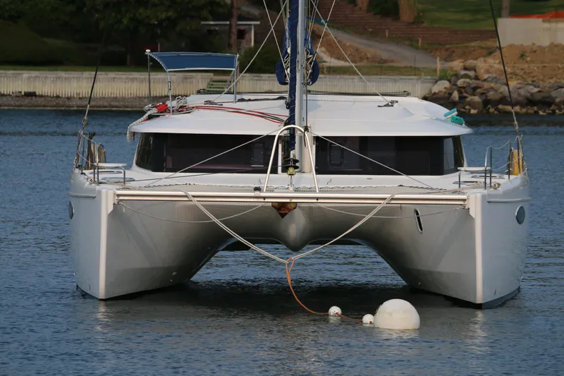 Slide: The Image of 2009 Fountaine Pajot Orana 44 catamaran anchored on calm water. - 12