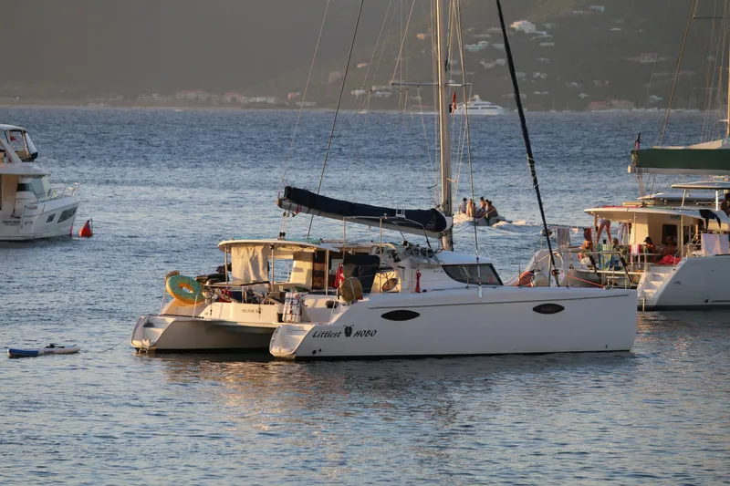 Slide: The Image of 2009 Fountaine Pajot Orana 44 catamaran anchored in a serene bay. - 16