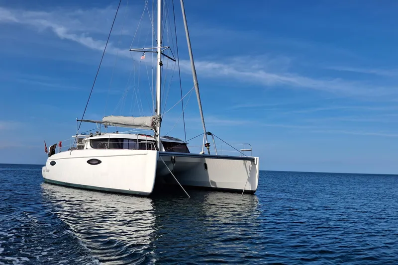 Slide: The Image of 2009 Fountaine Pajot Orana 44 catamaran sailing on calm blue waters. - 2