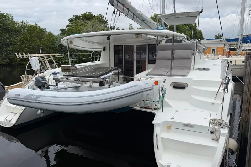 Slide: The Image of 2009 Fountaine Pajot Orana 44 catamaran docked, featuring spacious deck and inflatable dinghy. - 20