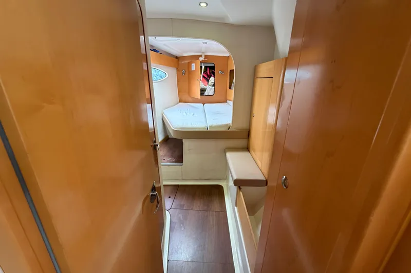 Slide: The Image of Interior cabin of 2009 Fountaine Pajot Orana 44 catamaran, featuring wooden finishes and cozy bed. - 21
