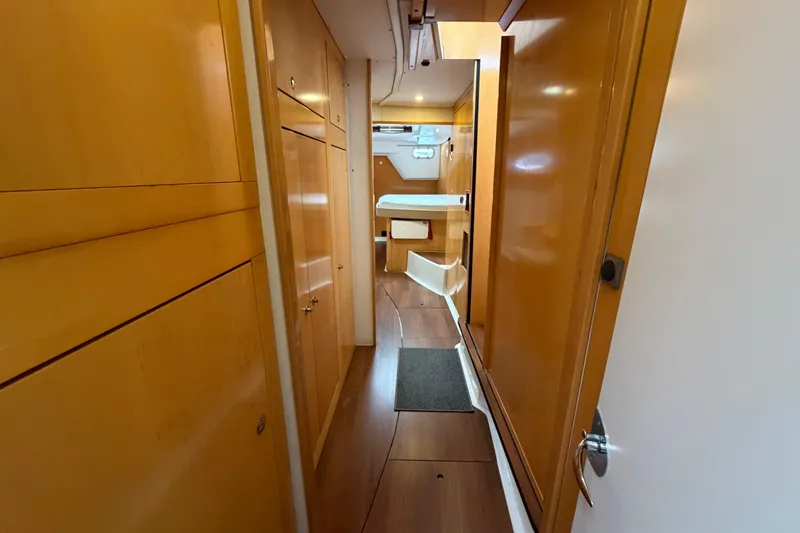 Slide: The Image of Interior hallway of 2009 Fountaine Pajot Orana 44 catamaran, featuring wooden cabinetry and flooring. - 22