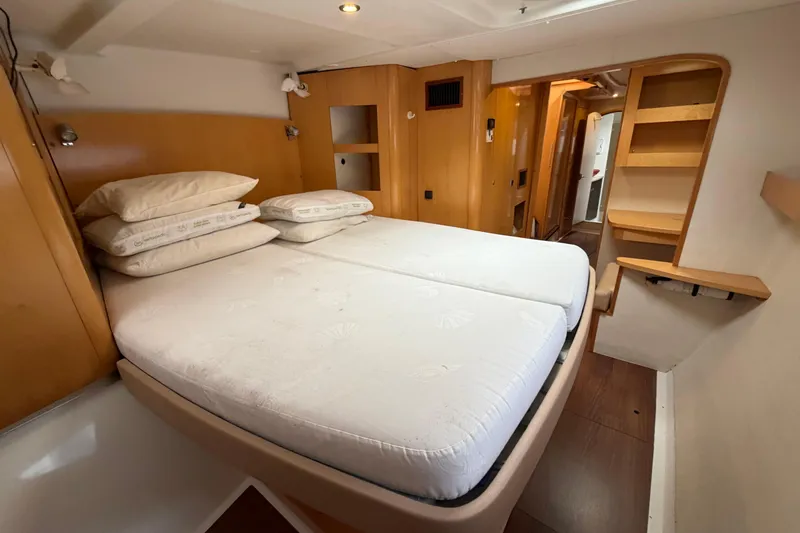 Slide: The Image of Interior cabin of 2009 Fountaine Pajot Orana 44 catamaran with cozy bed and wooden furnishings. - 26