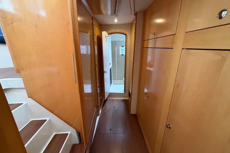Slide: The Image of Interior hallway of 2009 Fountaine Pajot Orana 44 catamaran, featuring wooden cabinetry and stairs. - 29