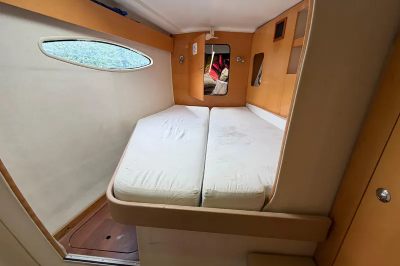 Slide: The Image of Interior cabin of 2009 Fountaine Pajot Orana 44 catamaran with twin beds and wooden accents. - 38