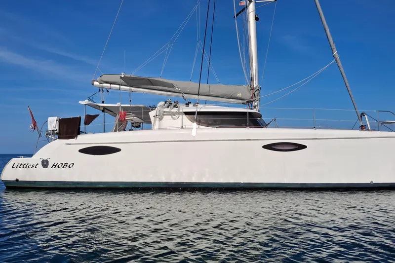 Slide: The Image of 2009 Fountaine Pajot Orana 44 catamaran on calm water under clear blue sky. - 4