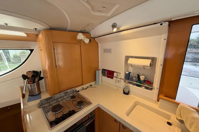 Slide: The Image of 2009 Fountaine Pajot Orana 44 yacht kitchen with stove, cabinets, and sink. - 41