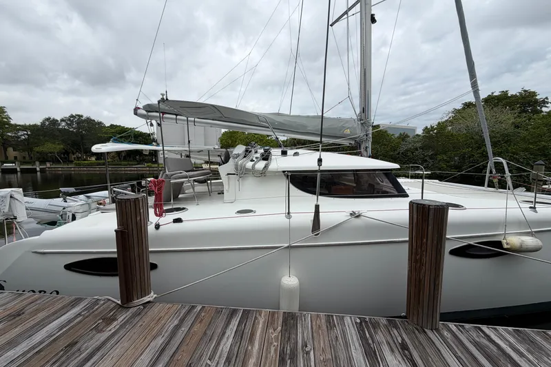 Slide: The Image of 2009 Fountaine Pajot Orana 44 catamaran docked, featuring sleek design and spacious deck. - 45