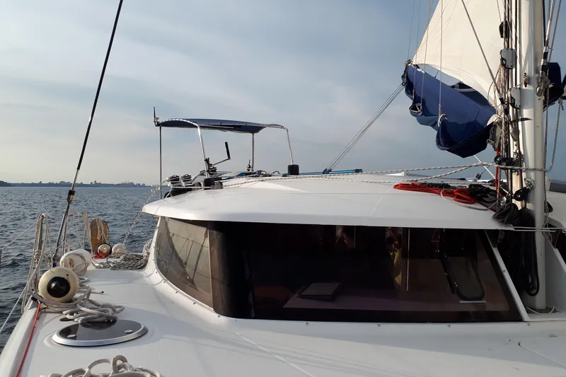 Slide: The Image of 2009 Fountaine Pajot Orana 44 catamaran sailing on open water, showcasing deck and sails. - 5