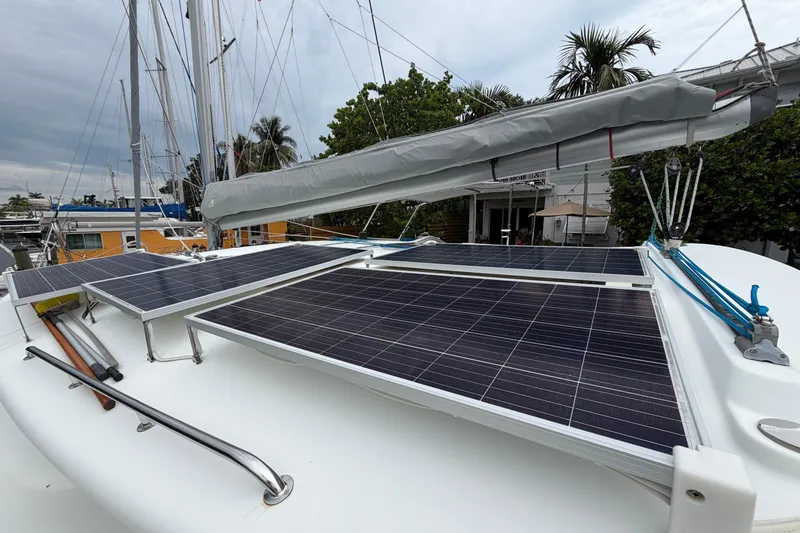 Slide: The Image of Solar panels on 2009 Fountaine Pajot Orana 44 catamaran deck, docked with palm trees nearby. - 53