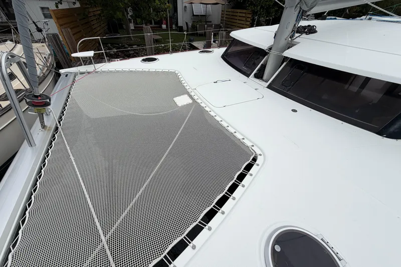 Slide: The Image of 2009 Fountaine Pajot Orana 44 catamaran deck with netting and sleek design. - 57