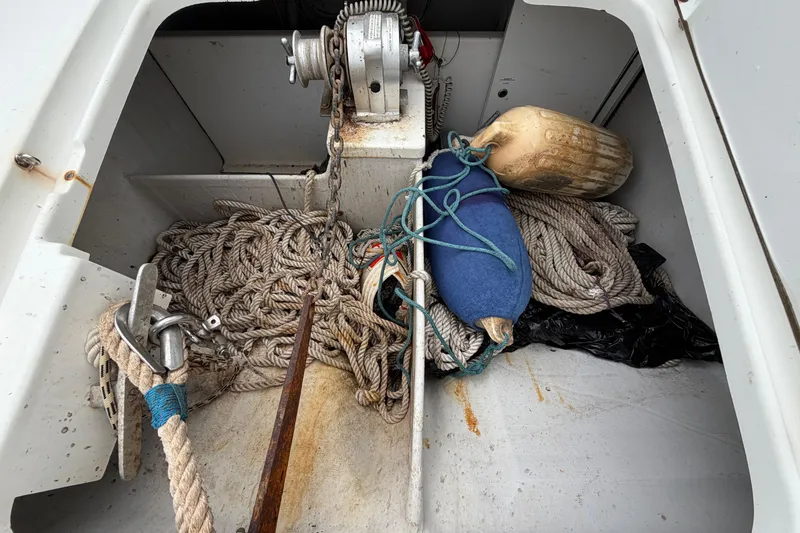 Slide: The Image of Anchor locker of 2009 Fountaine Pajot Orana 44 with ropes and fenders. - 58