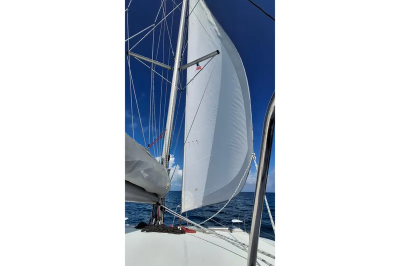 Slide: The Image of Sailing on a 2009 Fountaine Pajot Orana 44 catamaran with white sails against a clear blue sky. - 9