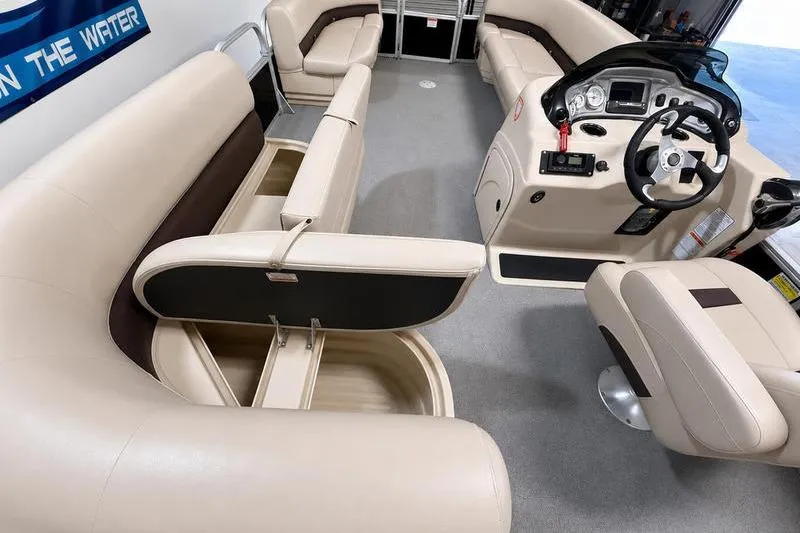 Slide: The Image of 2017 Sun Tracker Party Barge 22 DLX interior with beige seating and storage compartments. - 11