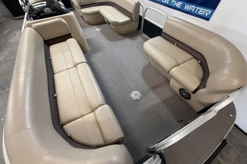 Slide: The Image of 2017 Sun Tracker Party Barge 22 DLX interior with beige seating and spacious layout. - 14
