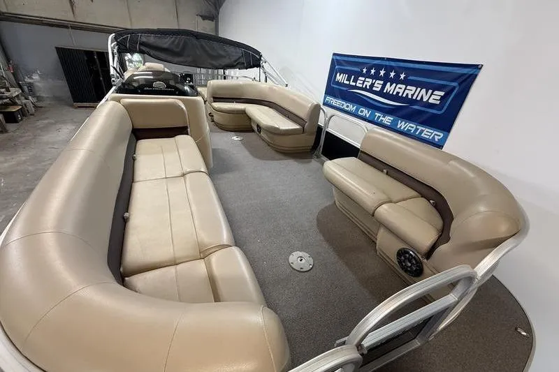Slide: The Image of 2017 Sun Tracker Party Barge 22 DLX interior with beige seating and spacious layout. - 15
