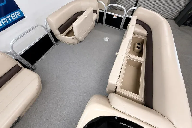 Slide: The Image of 2017 Sun Tracker Party Barge 22 DLX interior with beige seating and storage compartments. - 16