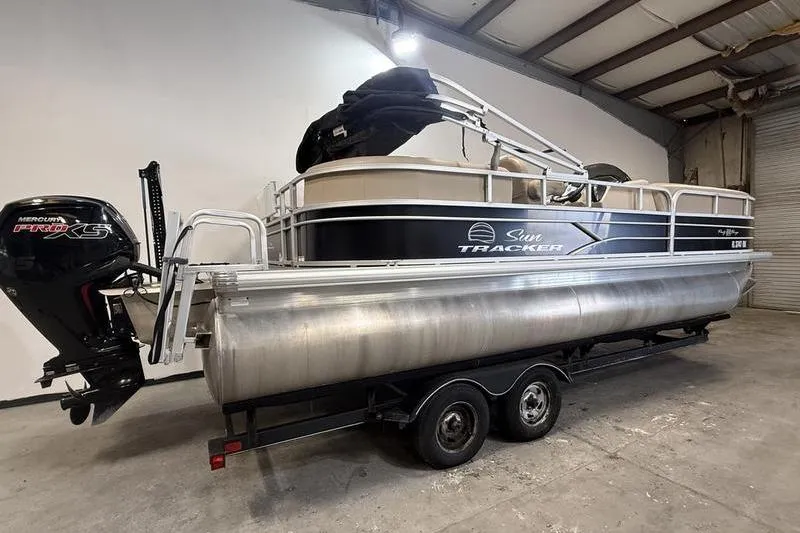 Slide: The Image of 2017 Sun Tracker Party Barge 22 DLX pontoon boat in storage facility. - 2