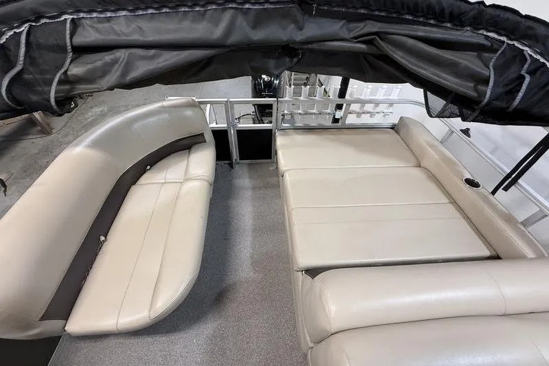 Slide: The Image of 2017 Sun Tracker Party Barge 22 DLX interior with beige seating and canopy. - 7