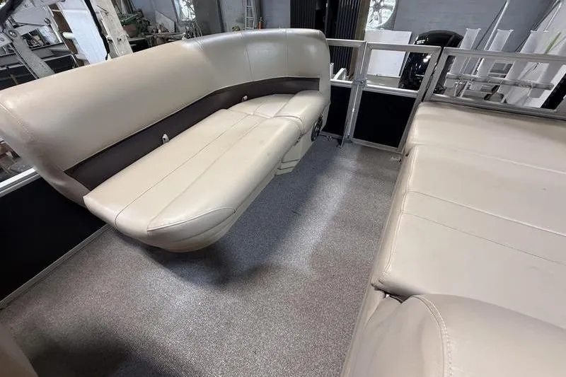 Slide: The Image of 2017 Sun Tracker Party Barge 22 DLX interior with beige seating and carpeted floor. - 8