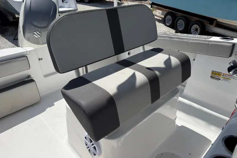 Slide: The Image of 2022 Aquasport 2300 Center Console boat interior with cushioned seating and console details. - 7
