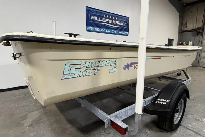 Slide: The Image of 1998 Carolina Skiff 1965 V boat on trailer in showroom. - 2