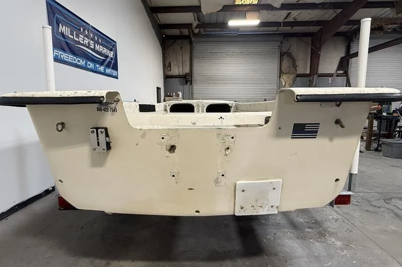 Slide: The Image of 1998 Carolina Skiff 1965 V boat in a warehouse, rear view. - 3