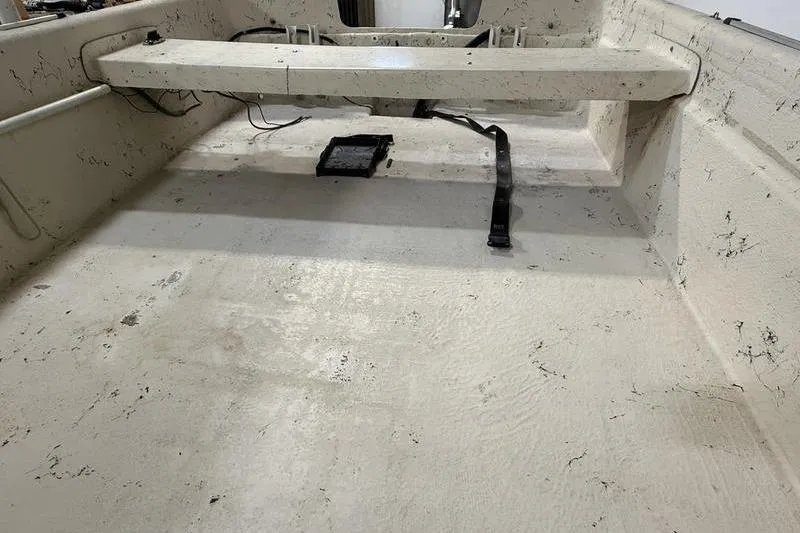 Slide: The Image of Interior of a 1998 Carolina Skiff 1965 V boat, showing seating and floor details. - 5