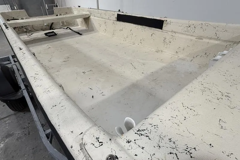 Slide: The Image of 1998 Carolina Skiff 1965 V boat interior with textured surface and minimal equipment. - 6