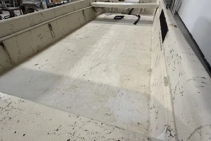 Slide: The Image of 1998 Carolina Skiff 1965 V boat interior with textured flooring and side rails. - 7