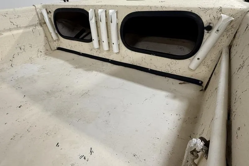 Slide: The Image of 1998 Carolina Skiff 1965 V interior with rod holders and storage compartments. - 8