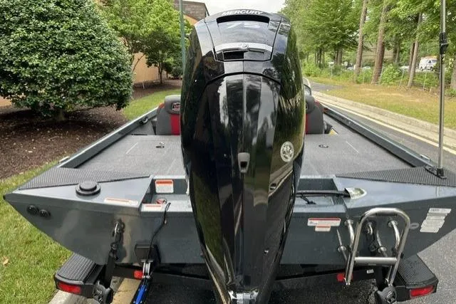 Slide: The Image of 2025 Ranger RT178 boat with Mercury outboard motor, parked on a trailer in a leafy area. - 7