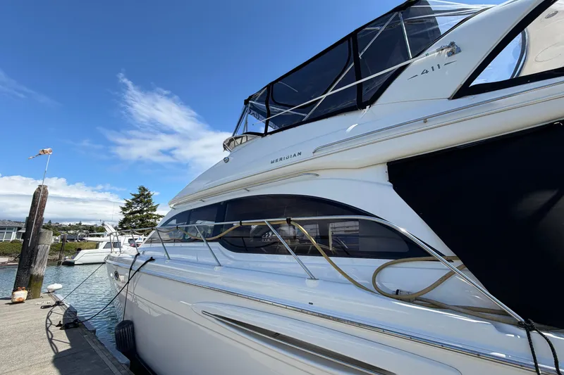 Slide: The Image of 2004 Meridian 411 Sedan yacht docked under clear blue sky. - 1