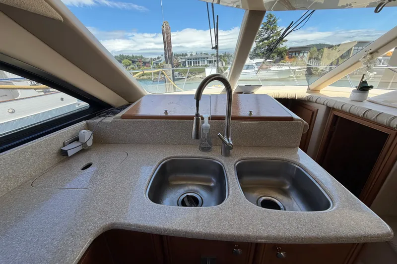 Slide: The Image of Interior view of 2004 Meridian 411 Sedan yacht kitchen with dual sinks and scenic window. - 11