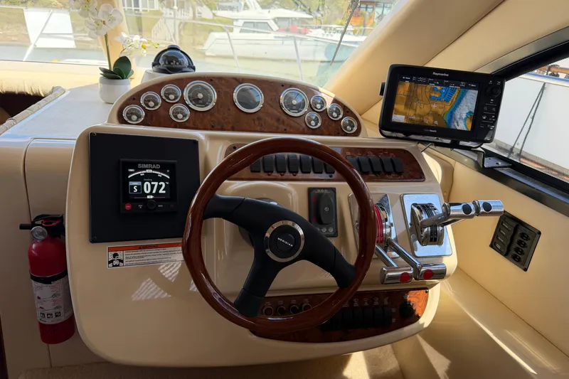 Slide: The Image of 2004 Meridian 411 Sedan helm with steering wheel, navigation displays, and control panel. - 12