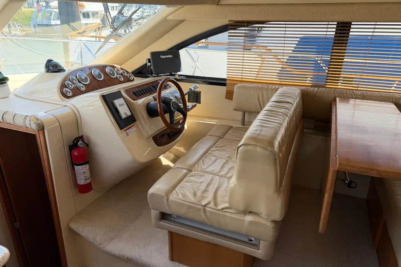 Slide: The Image of Interior of a 2004 Meridian 411 Sedan yacht with leather seating and wooden dashboard. - 13