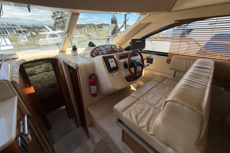 Slide: The Image of Interior of 2004 Meridian 411 Sedan yacht with leather seating and navigation controls. - 14