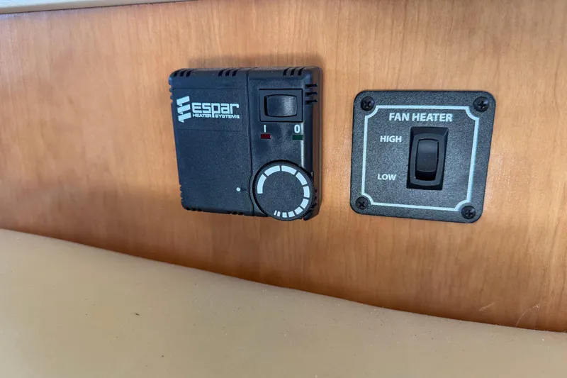 Slide: The Image of Espar heater controls and fan heater switch in 2004 Meridian 411 Sedan. - 15