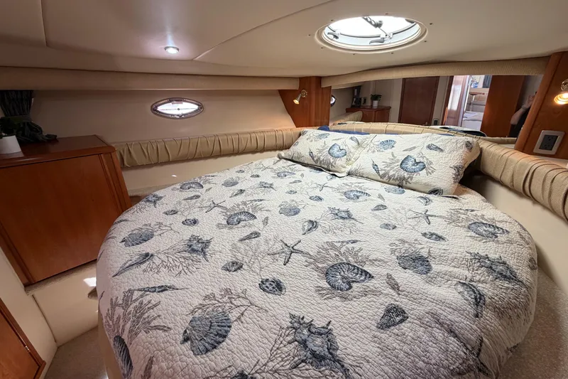 Slide: The Image of Luxurious 2004 Meridian 411 Sedan cabin with seashell-themed bedding and elegant wood accents. - 17